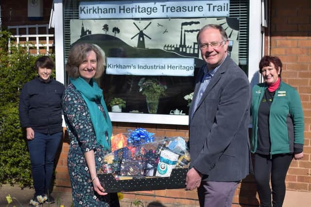 Adele and Peter Walsh (foreground) with their luxury hamper in front of their window display. They are joined by (left) artist Alex Blakey and (right) Barbara Parkinson, Morrisons Community Champion