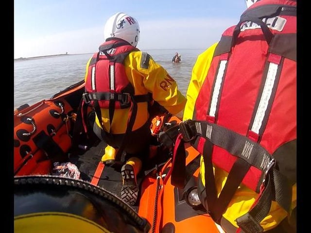 Anne Brookes, seen in the distance, was up to her waist in water