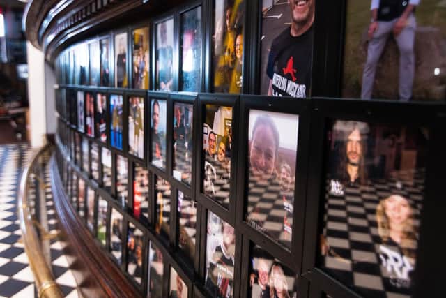 The bar inside Waterloo Music Bar is covered with photos of people who have helped keep them open.