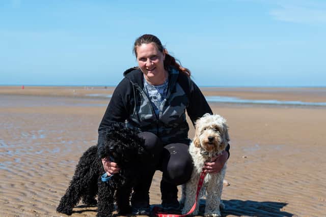 Anne Brookes with her two dogs Rockruss (black) and Lilypup (white) on Fleetwood beach. Anne was rescued by the RNLI whilst out walking with her dogs after the tide caught up to her. Photo: Kelvin Stuttard