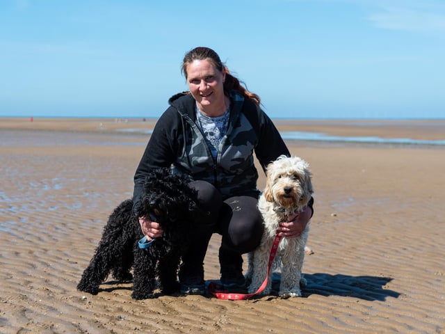 Anne Brookes with her two dogs Rockruss (black) and Lilypup (white) on Fleetwood beach. Anne was rescued by the RNLI whilst out walking with her dogs after the tide caught up to her. Photo: Kelvin Stuttard