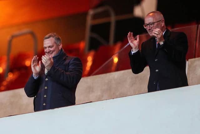 Chief executive Ben Mansford and director Brett Garrity applaud the players off the pitch at the Stadium of Light