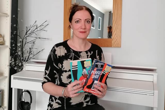 Football fan and author Eve Ainsworth pictured with her new book The Perfect Shot