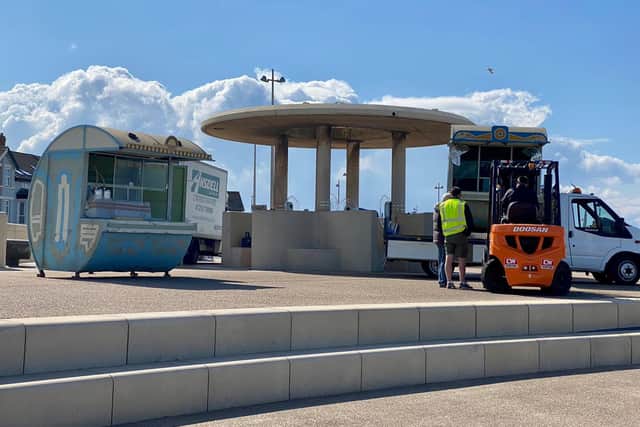 Props appearing to look like makeshift market stalls have been placed on the promenade.