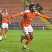 Ellis Simms scored both goals as Blackpool beat Doncaster to guarantee their place in the play-offs