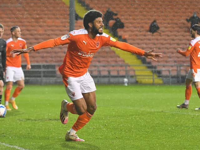 Ellis Simms scored both goals as Blackpool beat Doncaster to guarantee their place in the play-offs