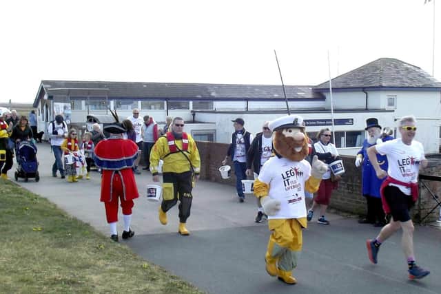 Fylde-based comedian Phil Walkjer with RNLI mascot Stormy Stan and other participants at the start of Leg It For the Lifeboats at Lytham RNLI station