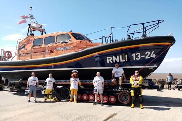 RNLI crew members at the St Annes boathouse after completing the three and a half mile run from Lytham