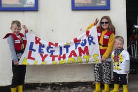 Thomas (age five) and Evie Booth (nine) with their cousin Freddie Bridge (22 months), son of crew member Will Bridge, showing their support for their fund raising at  start of Lytham St Annes RNLI's Leg It for the Lifeboats fund-raiser 2021