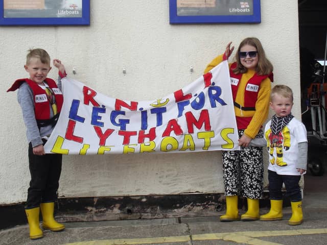 Thomas (age five) and Evie Booth (nine) with their cousin Freddie Bridge (22 months), son of crew member Will Bridge, showing their support for their fund raising at  start of Lytham St Annes RNLI's Leg It for the Lifeboats fund-raiser 2021