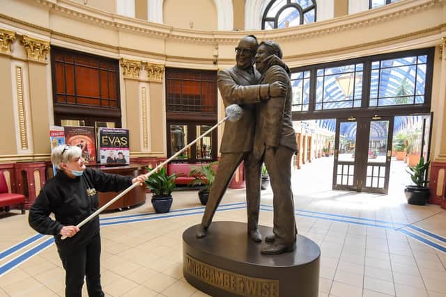 Coral Orgill cleans the Morecambe and Wise statue as the Winter Gardens prepares to reopen on May 17.