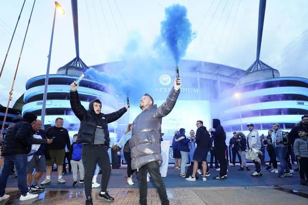 Fans celebrate outside Etihad Stadium as Manchester City are crowned champions