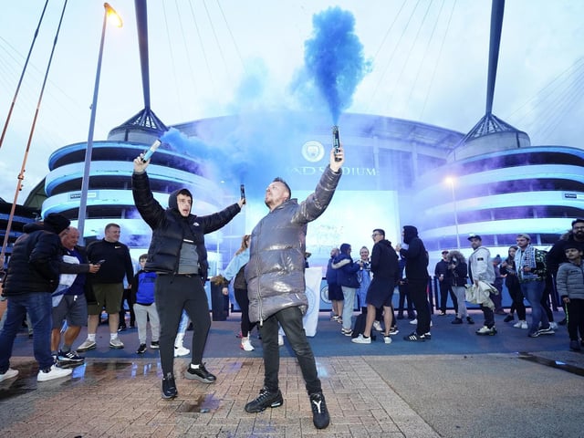 Fans celebrate outside Etihad Stadium as Manchester City are crowned champions