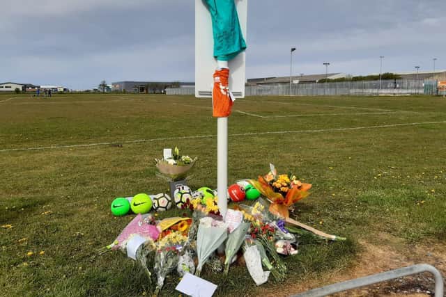 Flowers and football have been left at the scene in tribute to the 9-year-old boy who died on the Common Edge playing fields in South Shore yesterday (Tuesday, May 11)