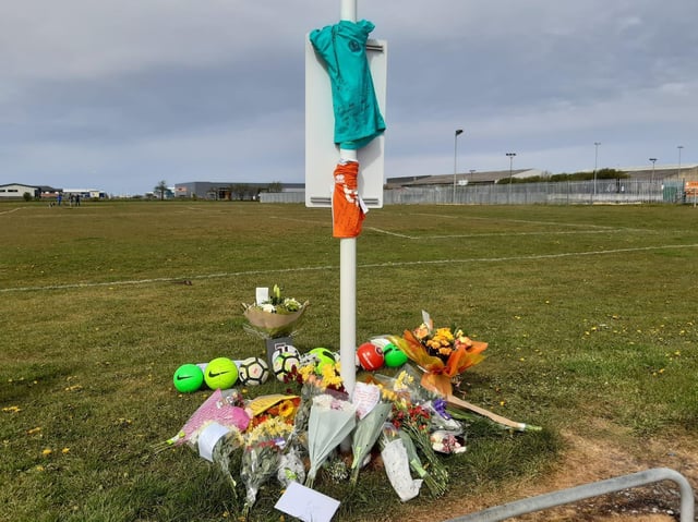Flowers and football have been left at the scene in tribute to the 9-year-old boy who died on the Common Edge playing fields in South Shore yesterday (Tuesday, May 11)