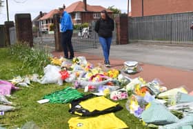 Flowers and football shirts left in memory of Jordan Banks