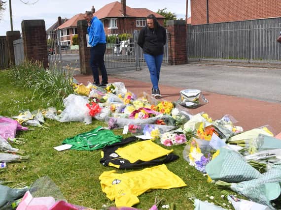 Flowers and football shirts left in memory of Jordan Banks