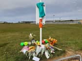 Nine footballs have left in tribute to 9-year-old Jordan Banks, who was struck by lightning during football training on the playing fields