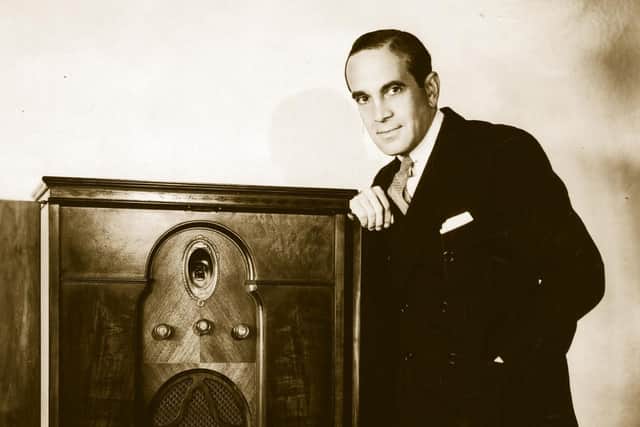 American singing entertainer Al Jolson leaning on a radiogram. Photo: Getty Images