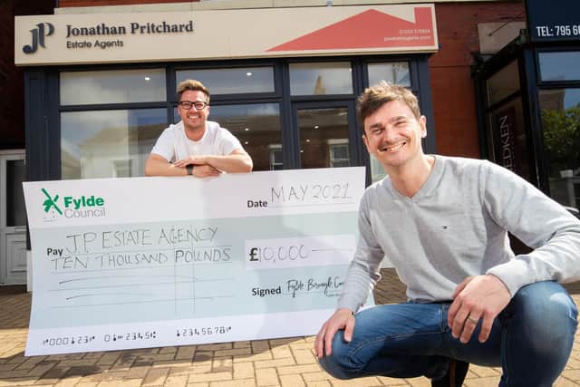 Estate agent Jonathan Pritchard (right) is presented with the grant cash by Coun Michael Sayward outside the premises in Station Road, Lytham