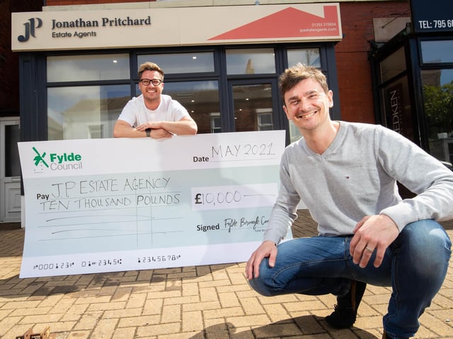 Estate agent Jonathan Pritchard (right) is presented with the grant cash by Coun Michael Sayward outside the premises in Station Road, Lytham