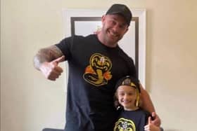 Jordan, 9, with his dad Matt Banks, pictured wearing their Cobra Kai t-shirts together