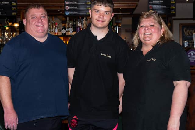 Chris, Christian and Karen Bracegirdle are ready to welcome customers inside the Boars Head Pub on Monday. Photo: Kelvin Stuttard
