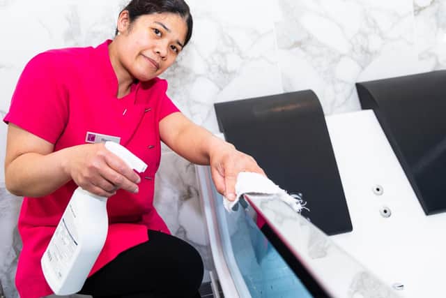 Rosie Makintura from housekeeping at Tiffany's cleans a bath in readiness for reopening on Monday. Photo: Kelvin Stuttard