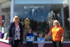 Teddy and Barnaby Couch receiving their certificates from Home-Start chief executive Pat Naylor (left) and shop manager Sue Uttley.
