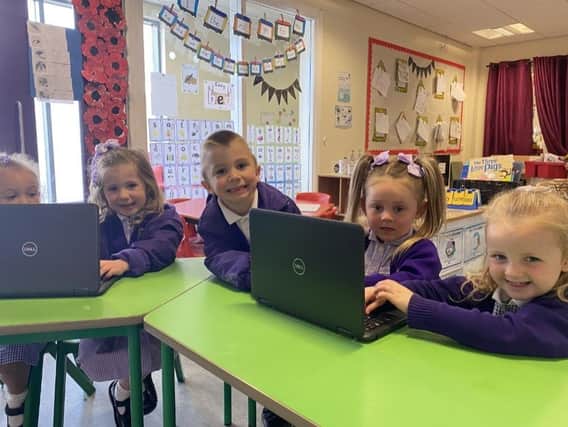 Children from St Wulstan's and St Edmund's Catholic Primary School test out new laptops donated to the school by Asda in Fleetwood