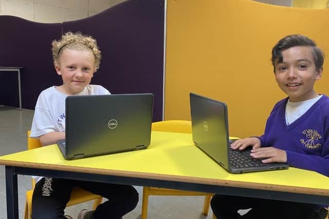 Archie Brooks and Bailey Keighley try out the new laptops donated to St Wulstan's and St Edmund's Catholic Primary School in Fleetwood