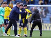 Karl Robinson with Neil Critchley at the full-time whistle