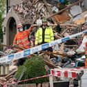 Emergency workers at the scene of a suspected gas explosion, in which a young child was killed and two people were seriously injured