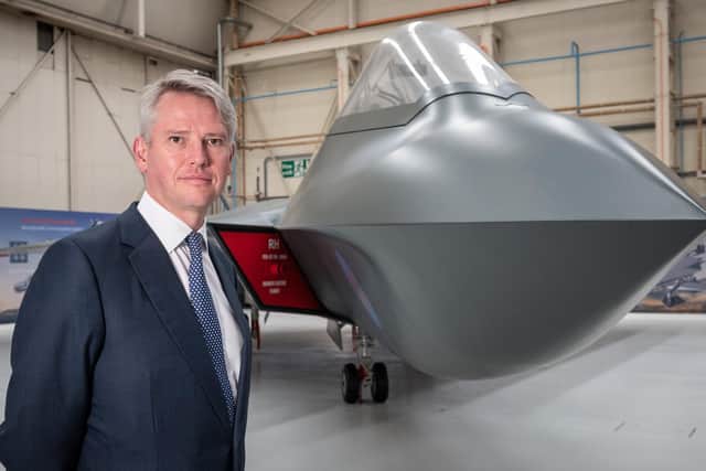 BAE Systems' chief executive Charles Woodburn pictured at Warton with the full sized mock-up of the next generation combat aircraft project, Tempest