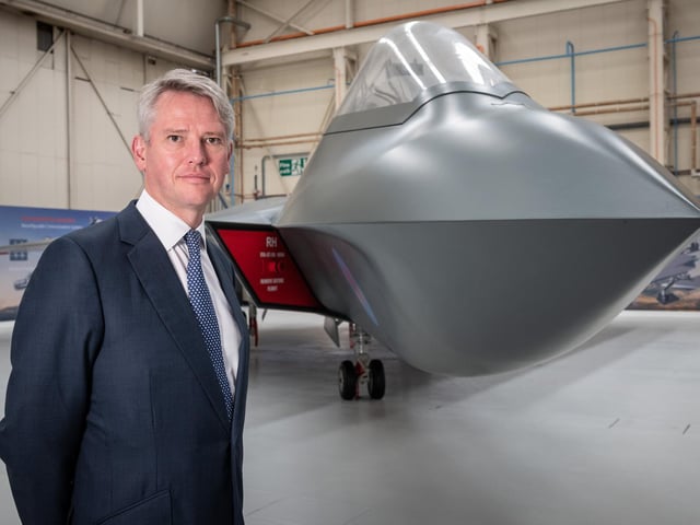 BAE Systems' chief executive Charles Woodburn pictured at Warton with the full sized mock-up of the next generation combat aircraft project, Tempest