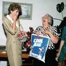 Princess Diana Princess of Wales, shares a joke with Chairman Kath Hayward and manager Marilyn Symonds at Relate Blackpool as she accepts a bag of gifts - including some Fleetwood Fish in 1992