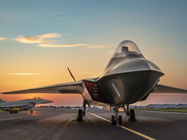 The full sized mock-up of the Tempest with a Typhoon on the runway behind it.