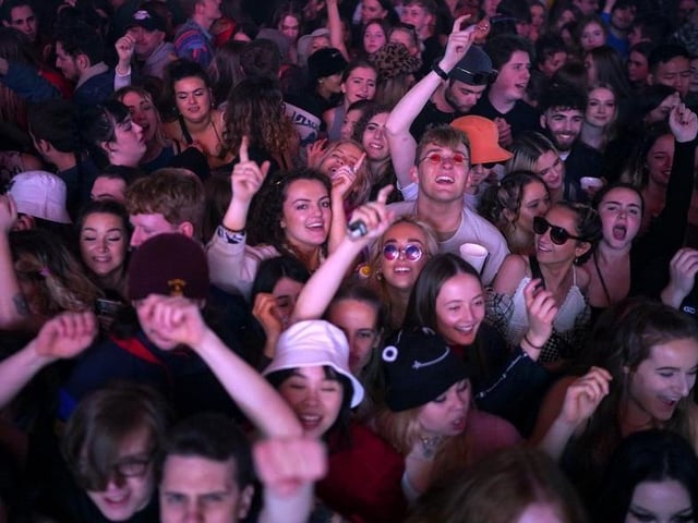 Concert-goers enjoy a non-socially distanced outdoor live music event at Sefton Park on May 2, 2021 in Liverpool.