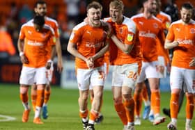 Dan Ballard (centre right) celebrates reaching Wembley with Elliot Embleton but the Blackpool defender sat out the second half of Friday's semi-final against Oxford