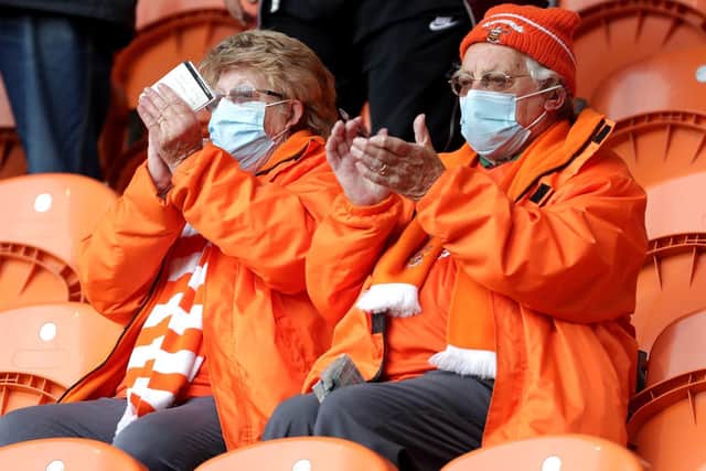 Two Blackpool fans saluting the club's progress to the Wembley play-off final with a 6-3 aggregate win in the semi-finals clinched at Bloomfield Road