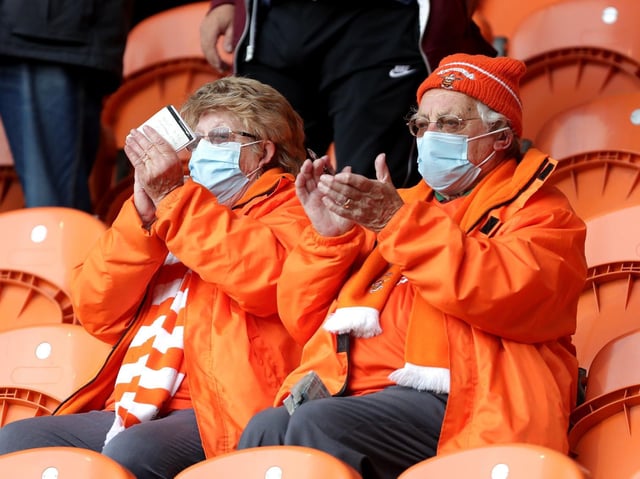 Two Blackpool fans saluting the club's progress to the Wembley play-off final with a 6-3 aggregate win in the semi-finals clinched at Bloomfield Road