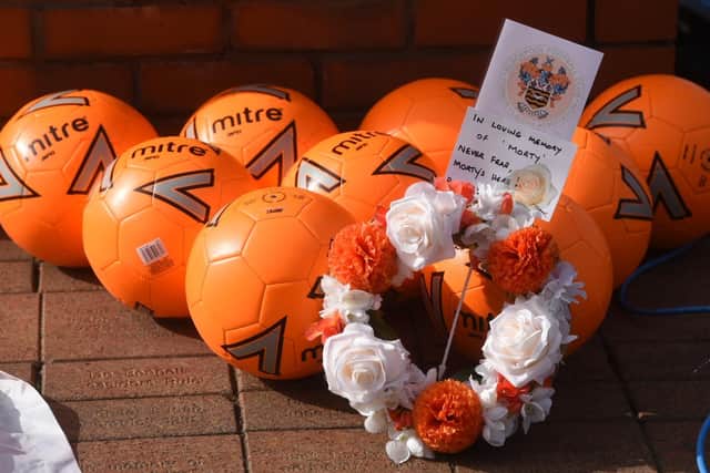 Nine tangerine footballs were laid at the foot of the Morty statue in tribute to Jordan Banks, the nine-year-old from Blackpool who was killed by lightning