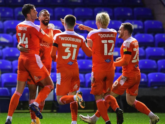 Gary Madine and Blackpool celebrate the striker's late winner at Peterborough United
