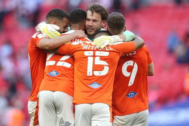 An emotional Chris Maxwell embraces teammates at Wembley