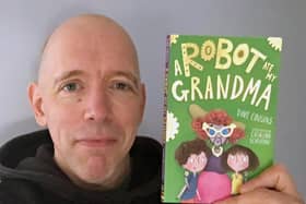 Dave Cousins with his latest book, A Robot Ate My Grandma