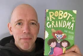 Dave Cousins with his latest book, A Robot Ate My Grandma