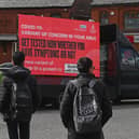 Information advising people to get tested due to the prevalence of a coronavirus covid-19 variant is displayed on a screen attached to a vehicle on the streets of Blackburn.