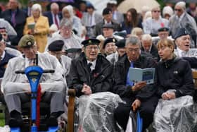 Veterans watch the official opening of the British Normandy Memorial in France via a live feed during a ceremony at the National Memorial Arboretum in Alrewas, Staffordshire