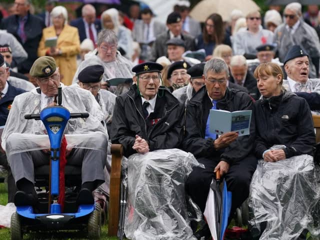 Veterans watch the official opening of the British Normandy Memorial in France via a live feed during a ceremony at the National Memorial Arboretum in Alrewas, Staffordshire