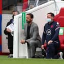 England's manager Gareth Southgate (L) and Steve Holland, Assistant Coach of England (R) 'take a knee' ahead of the international friendly football match between England and Romania at the Riverside Stadium in Middlesbrough.